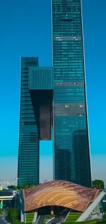 Modern skyscraper with unique architectural design against a clear blue sky.
