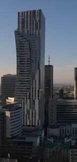 Modern skyscraper and city skyline at dusk.