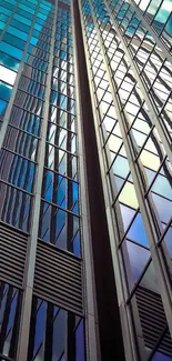 Skyscraper with reflective blue glass panels under a clear sky.