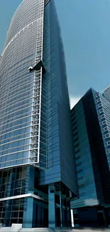 Tall, sleek skyscrapers under a vibrant blue sky.