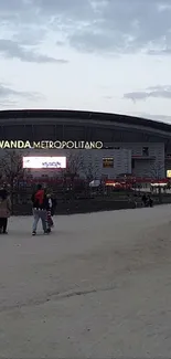 Urban stadium under a serene dusk sky.