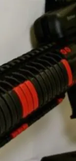 Close-up of a tactical weapon with red accents on a black rifle.