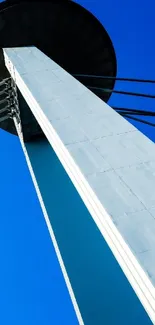 Modern tower against a vivid blue sky.