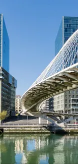 Modern urban bridge between skyscrapers reflected in water.