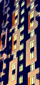 Night view of modern building with geometric design and lit windows.