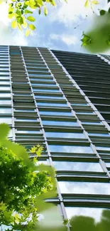 A skyscraper amidst green foliage under a blue sky.