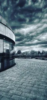 Modern urban architecture with dramatic clouds in grayscale.