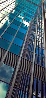 Upward view of blue glass skyscrapers reflecting the sky.