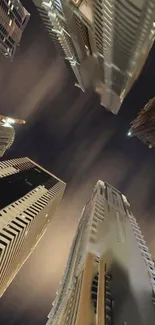 Upward view of city skyscrapers at night.