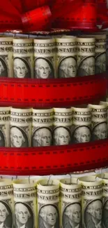 A cake of dollar bills with red ribbon decoration.