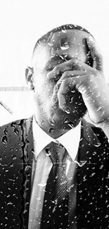 Monochrome portrait of a thoughtful man in business attire.