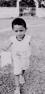 Monochrome image of child walking on grass