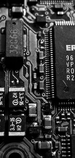 Monochrome close-up of a circuit board with detailed electronic components.