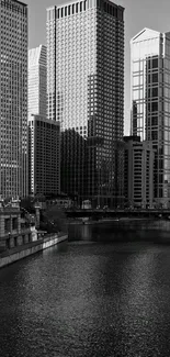 Monochrome city skyline with river reflection.