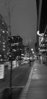 Black and white city street at night.