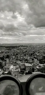 Monochrome cityscape with dramatic clouds viewed from above.
