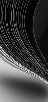 Curved monochrome paper art design on mobile background.