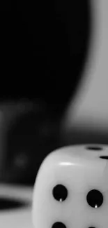 Black and white dice on a minimalist gray background.