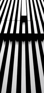 Monochrome geometric wallpaper with bold black lines creating optical patterns.