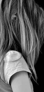 Side profile of a girl in monochrome wallpaper with black background.