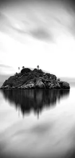 Monochrome island reflecting on calm water, creating a serene mobile wallpaper.