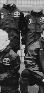 Monochrome image of smiling kids in sports uniforms.