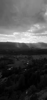 Monochrome landscape with mountains and dramatic skies, creating a serene ambiance.