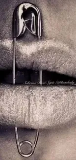 Monochrome lips with safety pin artwork.