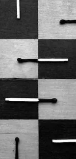 Monochrome checkered background with matchsticks.