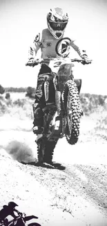 Black and white motocross bike jump wallpaper showcasing adventure and thrill.