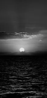 Black and white sunset over a calm ocean.