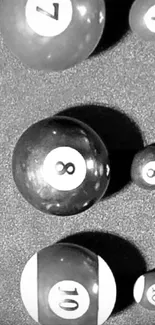 Monochrome pool balls art on mobile wallpaper.