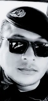 Black and white portrait with sunglasses and beret.