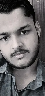 Monochrome portrait of a person against a wooden background wallpaper.