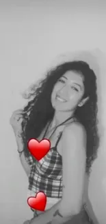 Monochrome image with smiling woman and red hearts on a white background.