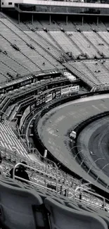 Monochrome aerial view of racing stadium with empty stands.