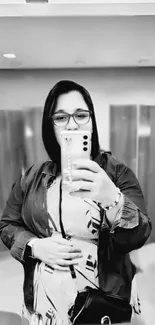 Monochrome mirror selfie capturing stylish reflection and elegant vibe.