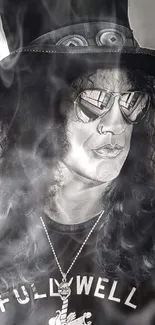 Monochrome portrait of a rock icon with a top hat and sunglasses.