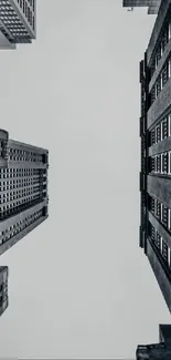 Monochrome city buildings viewed from below.