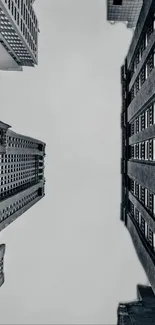 Monochrome view of towering city buildings in an urban skyline, showcasing dramatic architecture.