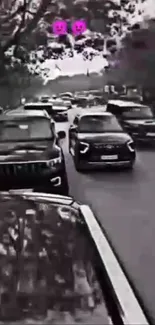 Black and white image of cars on a busy city street.