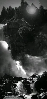 Monochrome waterfall with rocks and trees in serene landscape.