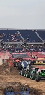 Monster trucks racing on dirt at a stadium arena.