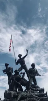 Monumental statue against a dramatic cloudy blue sky.