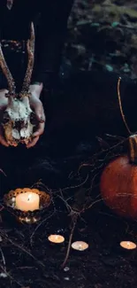 Moody Halloween wallpaper with pumpkin, candles, and skull in an autumn setting.