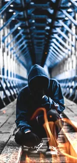 Hooded figure crouching on a bridge in blue.