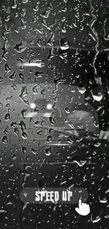 Raindrops on window with a car silhouette.