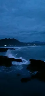 Serene coastal scene at dusk with dark blue ocean and sky.