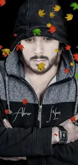 Moody portrait in hoodie with autumn leaves.