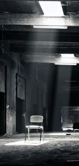 A moody industrial warehouse with a spotlight on a lone chair.